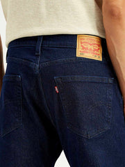 Close-up of Levi's men's regular blue jeans showing denim fabric and stitching details.
