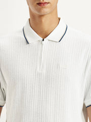 Men's solid white slim fit polo t-shirt by Levis, featuring a classic collar and short sleeves, displayed on a neutral background.