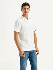Levi's men's solid white slim fit polo t-shirt displayed from the side, featuring a classic collar and short sleeves.