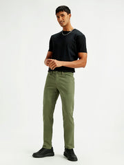 Levi's men's slim fit mid-rise jeans in olive green, showcasing front view with pockets and classic denim texture.