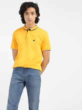Levi's men's yellow polo collar T-shirt, focus on front view showing classic collar and short sleeves, casual style.