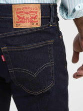 Levi's men's navy blue slim fit mid-rise jeans, back view showing waistband and rear pockets with subtle stitching details.