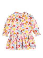 Pink girls' midi dress with printed candy wrapper sleeve design from Somersault, featuring a playful and colorful pattern.