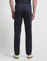 Arrow Sport men's solid Bronson slim fit casual trousers, showing navy blue fabric, front pockets, and tailored slim silhouette.