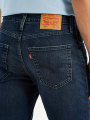 Close-up of Levi's men's jeans showing denim texture and stitching details, style A6634-0065 in a natural pose.