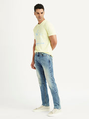 Levi's men's blue 511 slim fit mid-rise jeans shown from the side, featuring classic denim texture and modern slim silhouette.