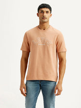 Levi's men's embroidered peach crew neck T-shirt with short sleeves, featuring colorful embroidery on the front.