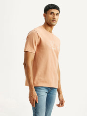 Levi's men's embroidered peach crew neck T-shirt with short sleeves, displayed from a side view showing embroidery details.