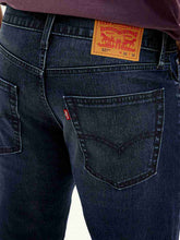 Levi's men's jeans in classic blue denim, detailed close-up showing stitching and fabric texture.