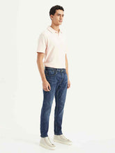Levis men's jeans in classic blue denim, straight fit, visible front pockets and belt loops, casual style for everyday wear