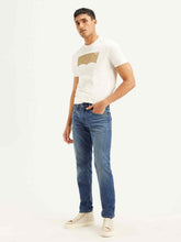 Levi's men's blue slim fit mid-rise jeans shown on a model, casual style, classic five-pocket design, mid-length cut.