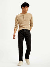 Men's Levis 511 black slim fit mid-rise jeans displayed on a hanger, showcasing classic denim style and modern fit.