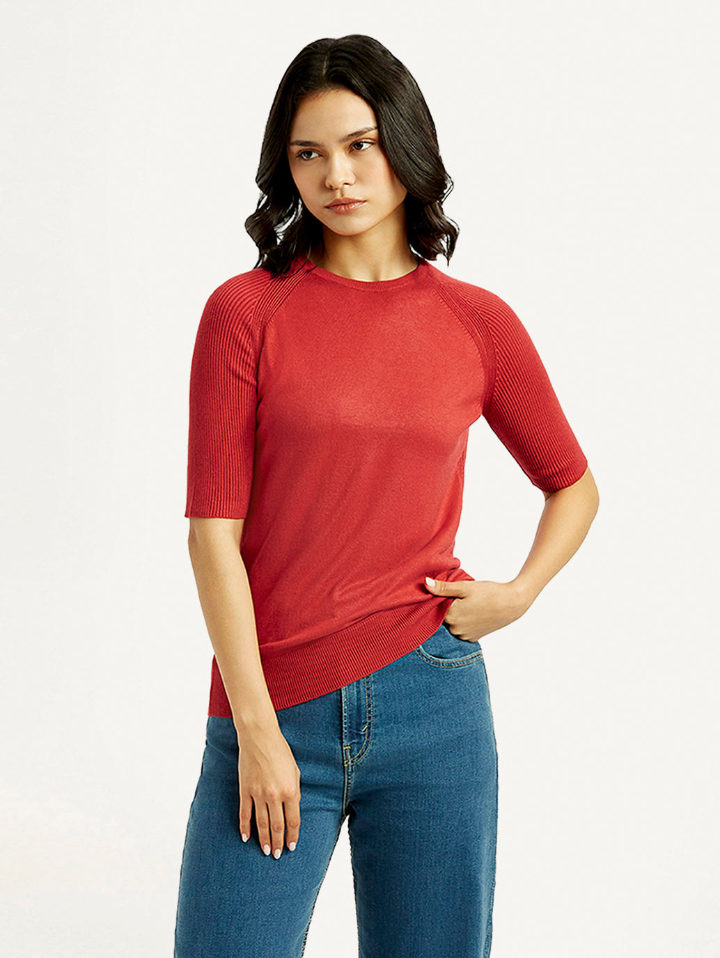 Levi's women's solid red crew neck top displayed on a model, showcasing casual style and comfortable fit.