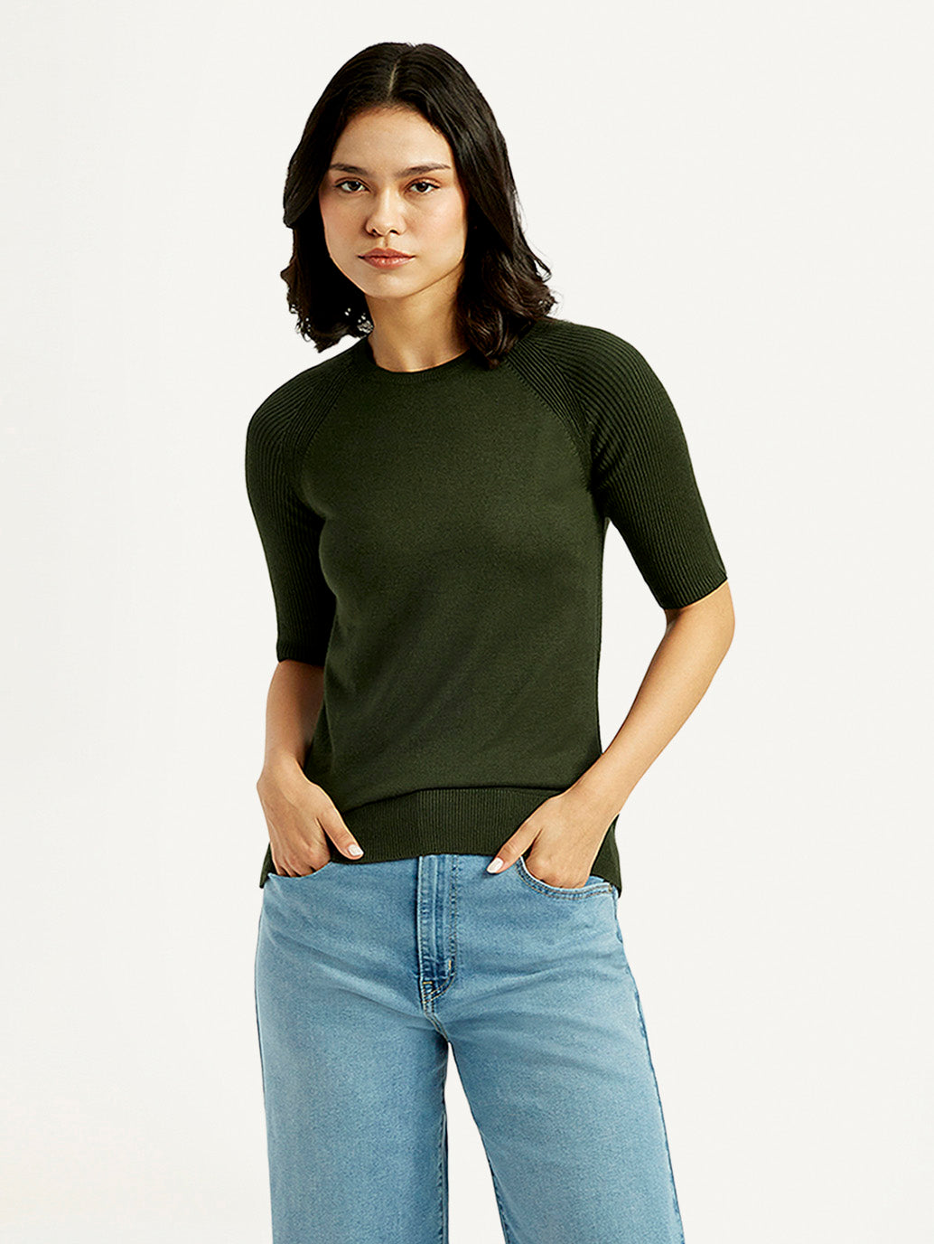 Levis women's solid dark green crew neck top displayed on a model, casual style with long sleeves and a comfortable fit.