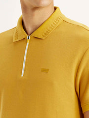 Levis men's slim fit yellow polo t-shirt with short sleeves, detailed close-up showing fabric texture and collar.