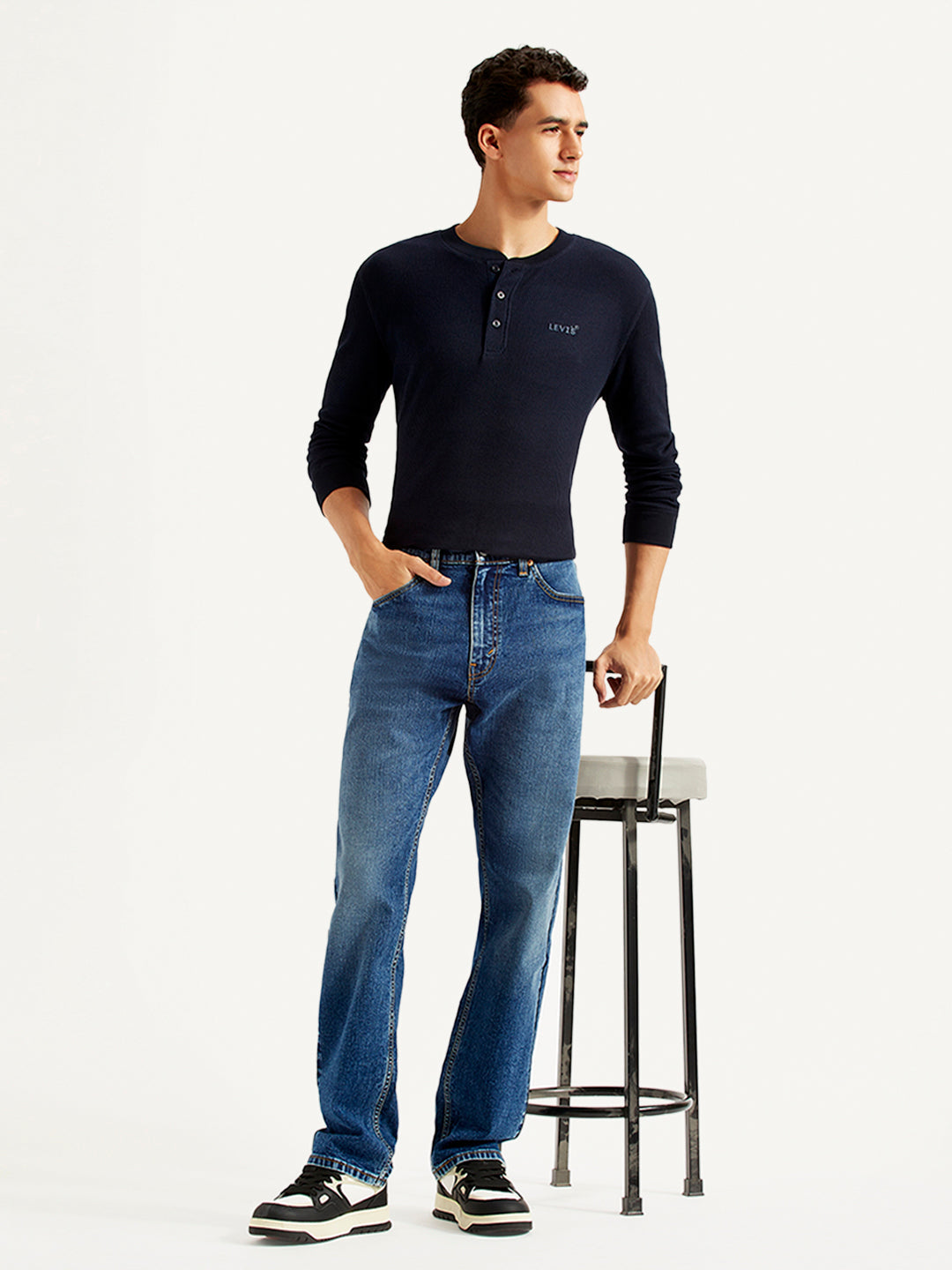 Levi's men's 505 blue straight fit mid-rise jeans displayed on a model, showcasing the classic denim style and fit.