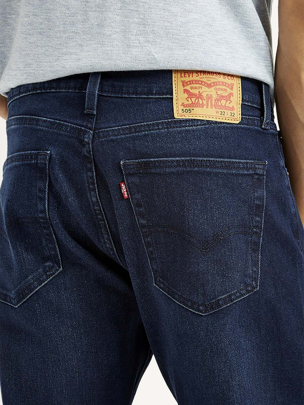 Close-up of Levi's men's jeans showing denim fabric and detailed stitching in a natural posture.