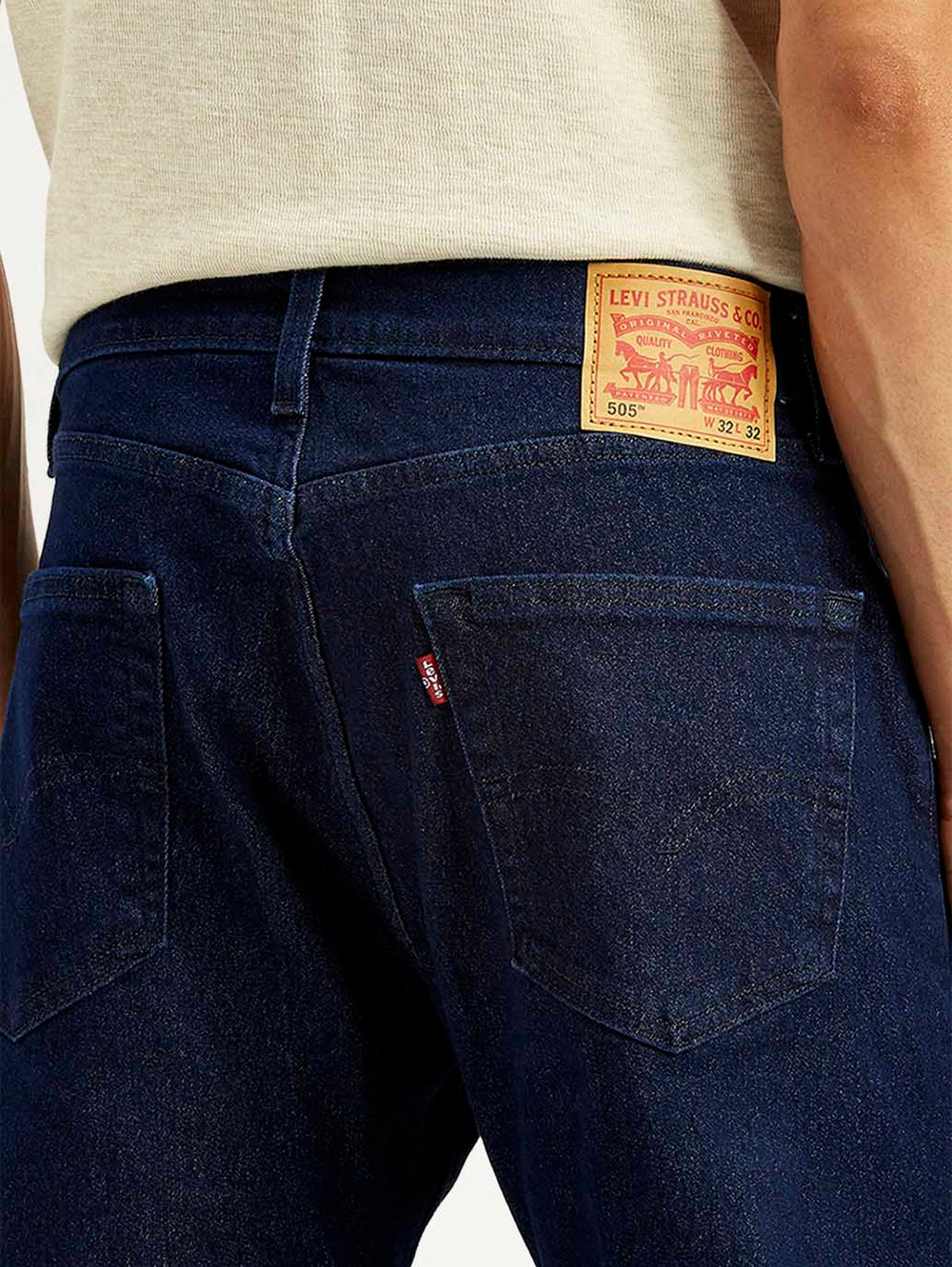 Close-up of Levi's men's regular blue jeans showing denim fabric and stitching details.