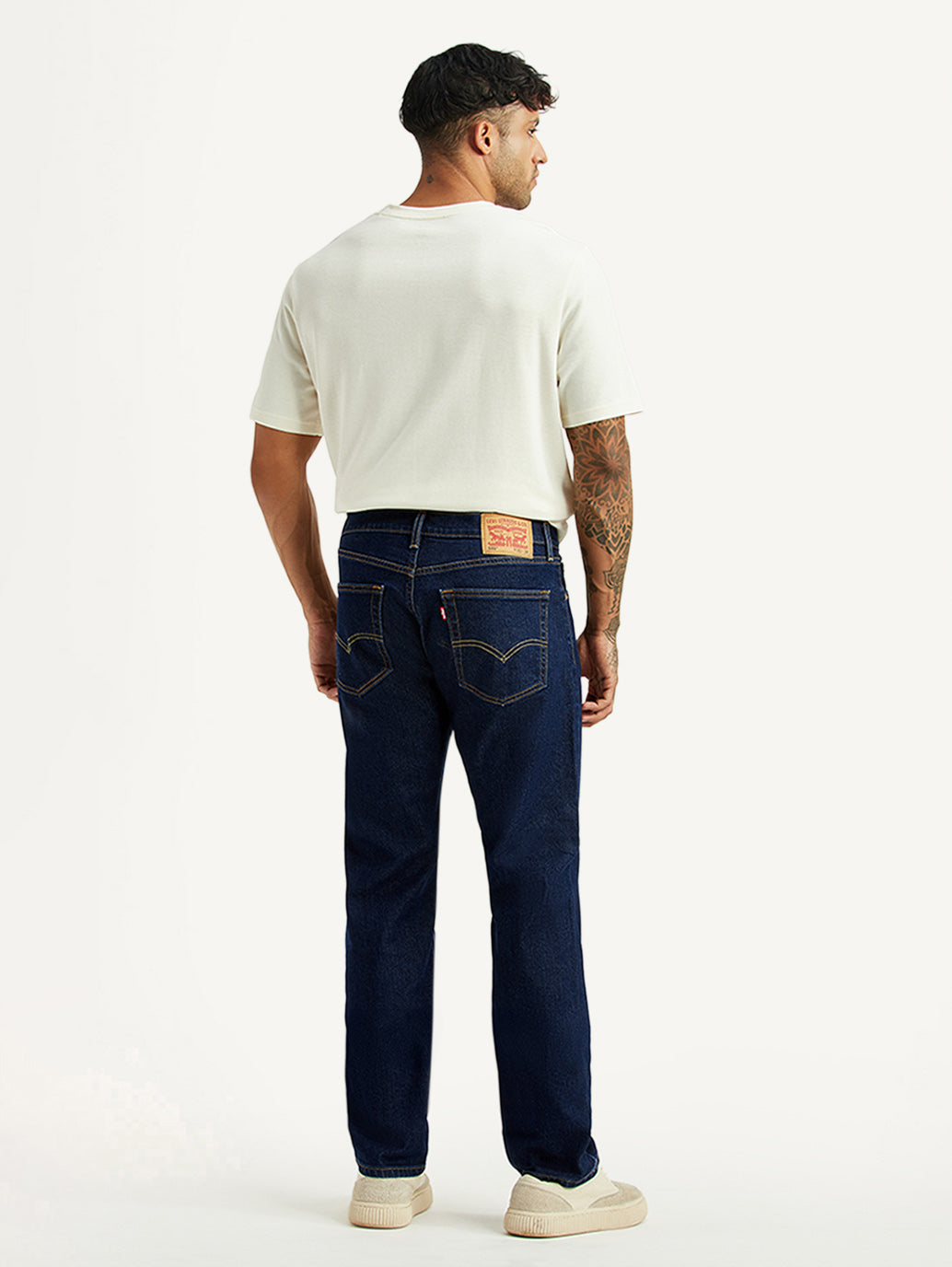 Levi's men's 505 dark blue straight fit mid-rise jeans shown from the back, with classic denim texture and stitching details.