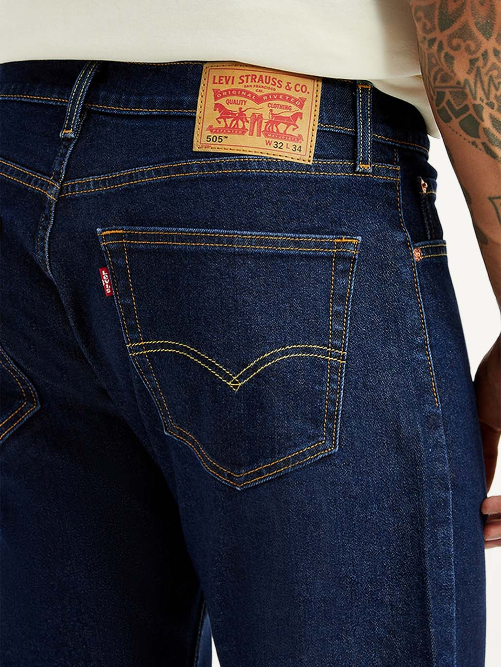 Levi's men's 505 dark blue straight fit mid-rise jeans with detailed stitching and classic denim texture.