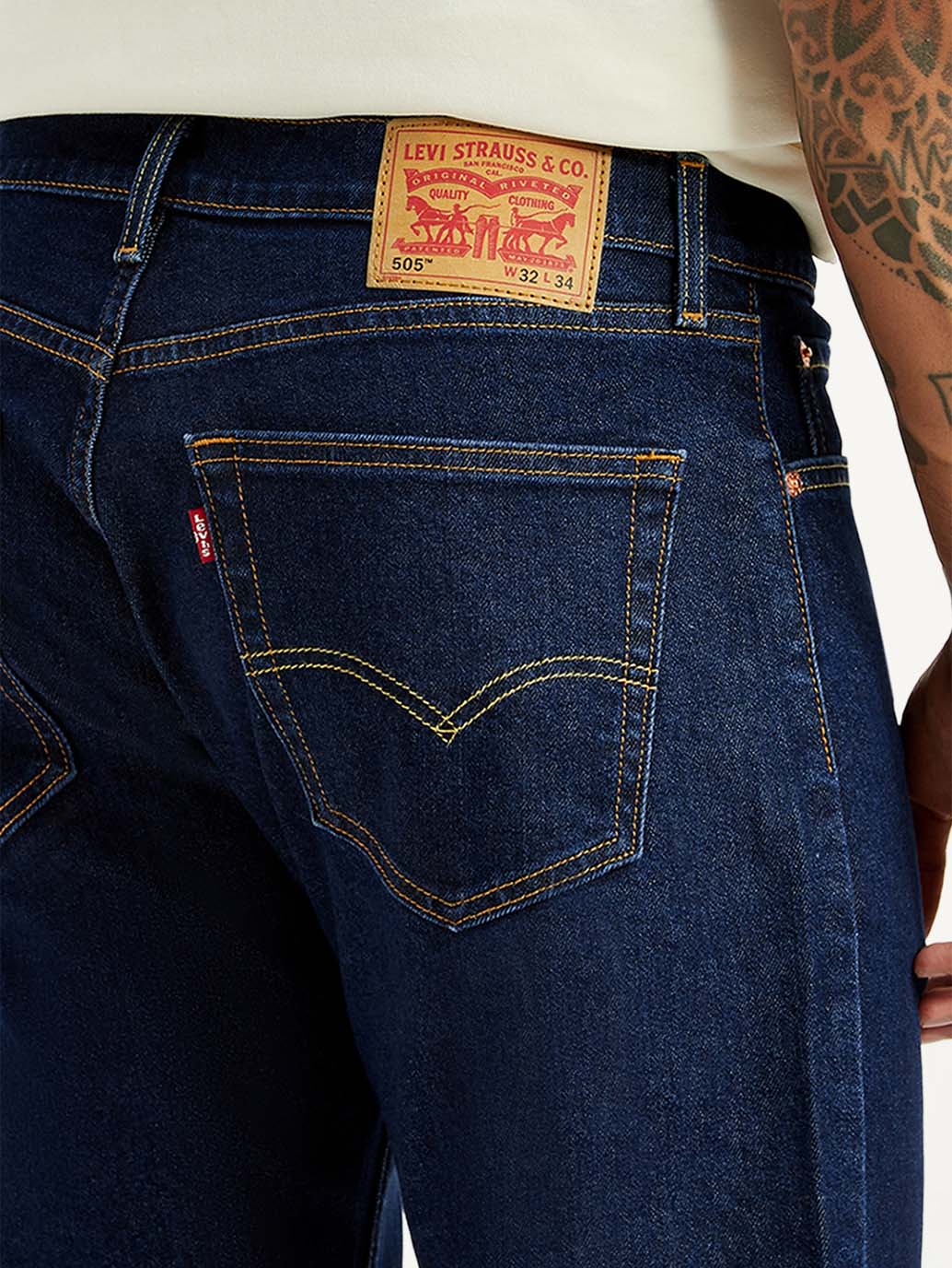 Levi's men's 505 dark blue straight fit mid-rise jeans with detailed stitching and classic denim texture.