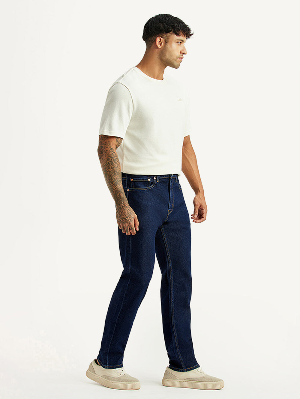 Levi's men's 505 dark blue straight fit mid-rise jeans shown from the side, casual denim pants for men with classic style.
