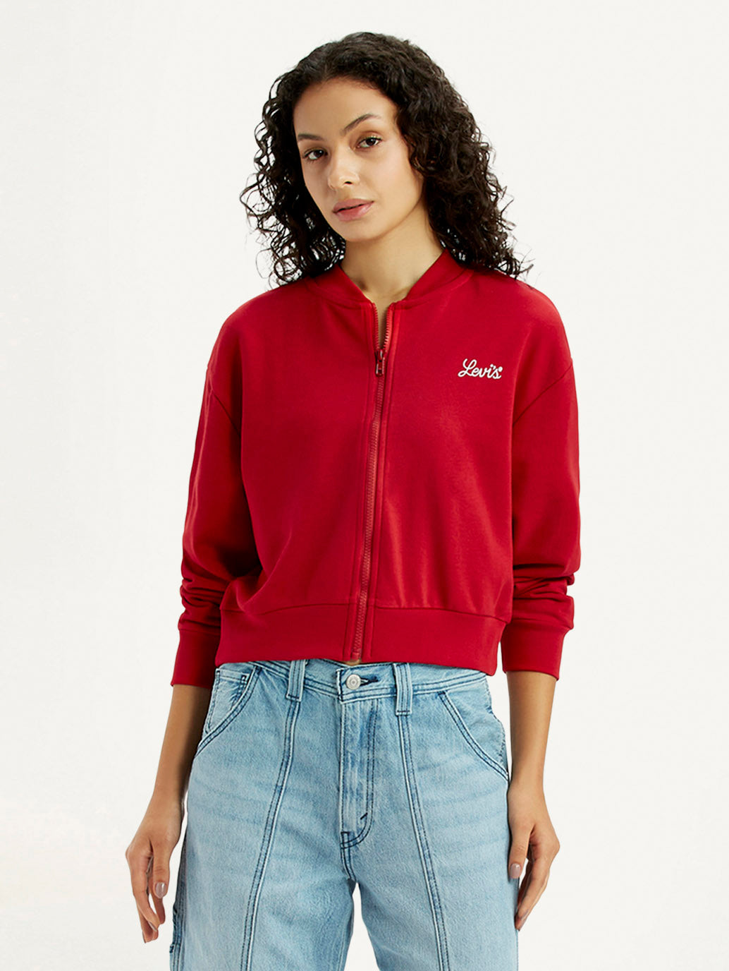 Levis women's red collar neck sweatshirt featuring the brand logo, shown on a model with a casual western-style look.