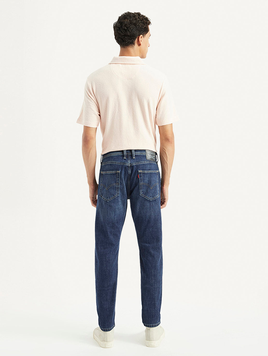 Back view of Levi's men's jeans 002IY-0000 in classic denim with visible stitching and pockets, showcasing casual men's lower wear.
