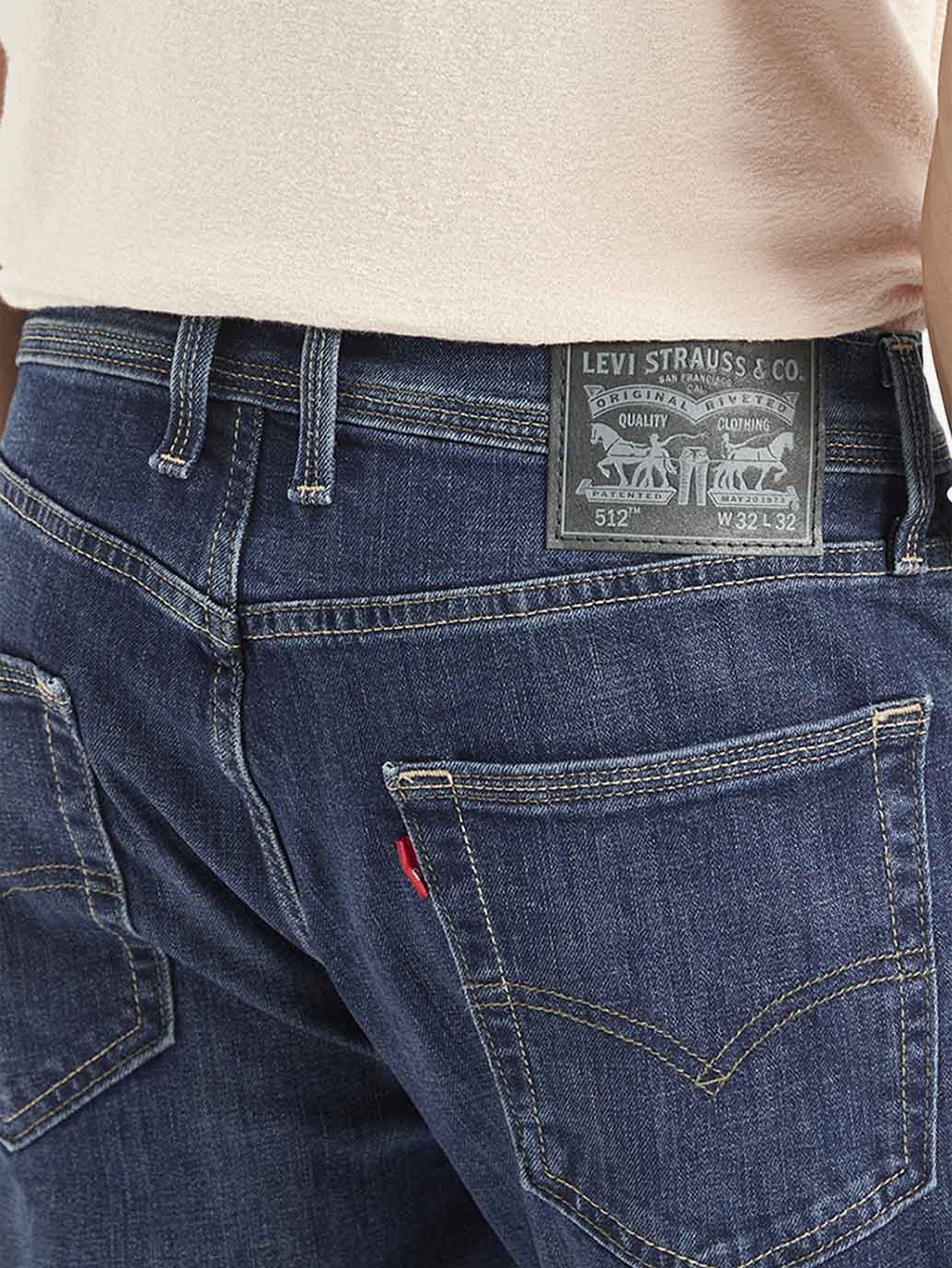 Close-up of Levi's men's jeans in dark wash, showing detailed stitching and fabric texture.