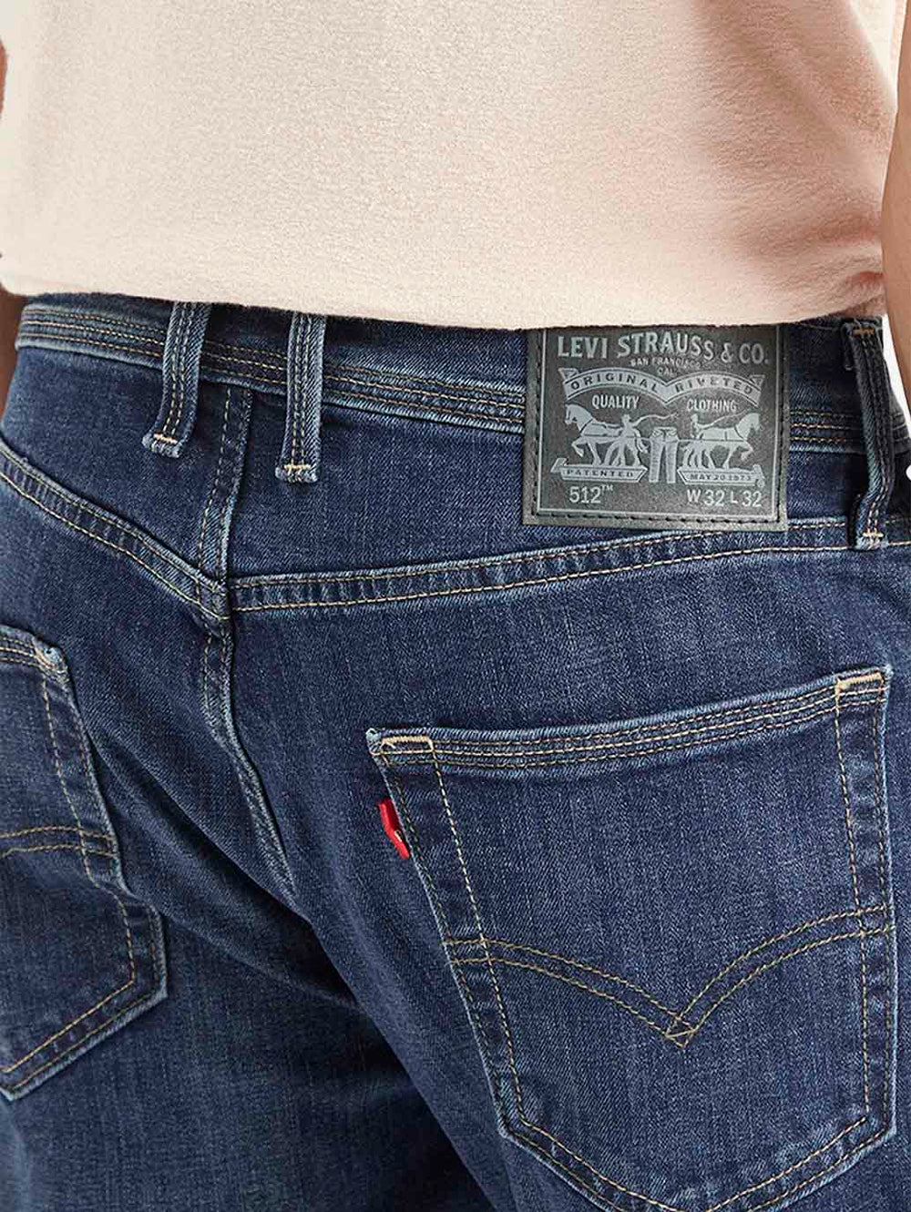 Close-up of Levi's men's jeans in dark wash, showing detailed stitching and fabric texture.