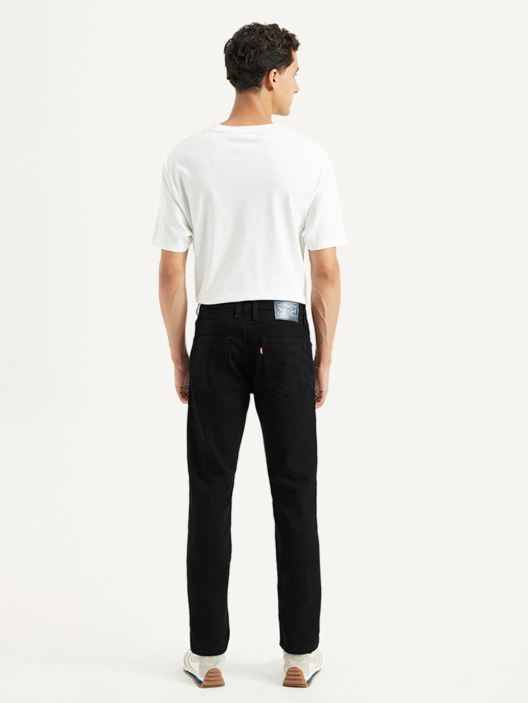 Levi's men's 511 black slim fit mid-rise jeans shown from the back with classic five-pocket design and stitched detailing.