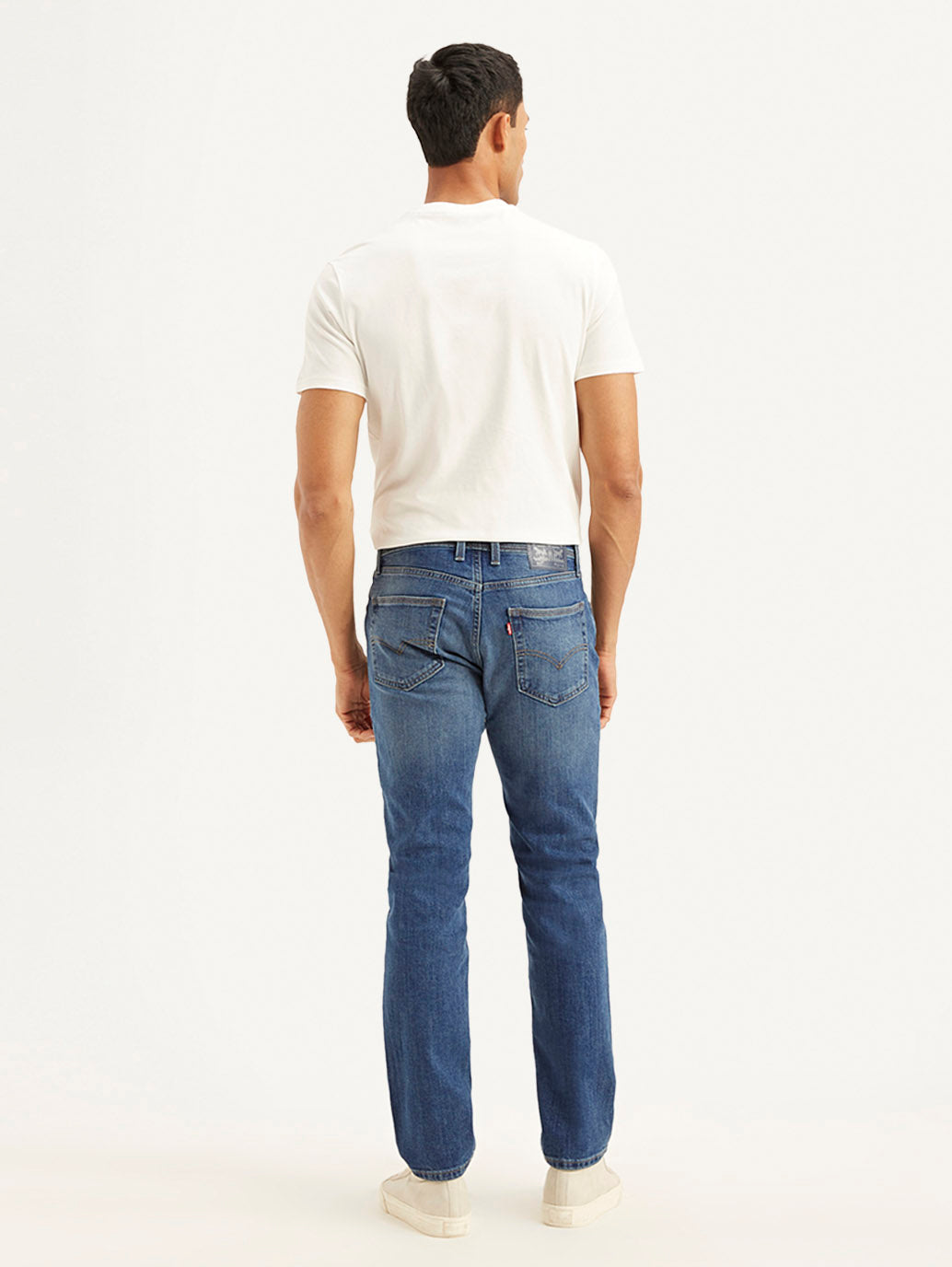 Back view of Levis men's 511 blue slim fit mid-rise jeans showing rear pockets and classic denim design.