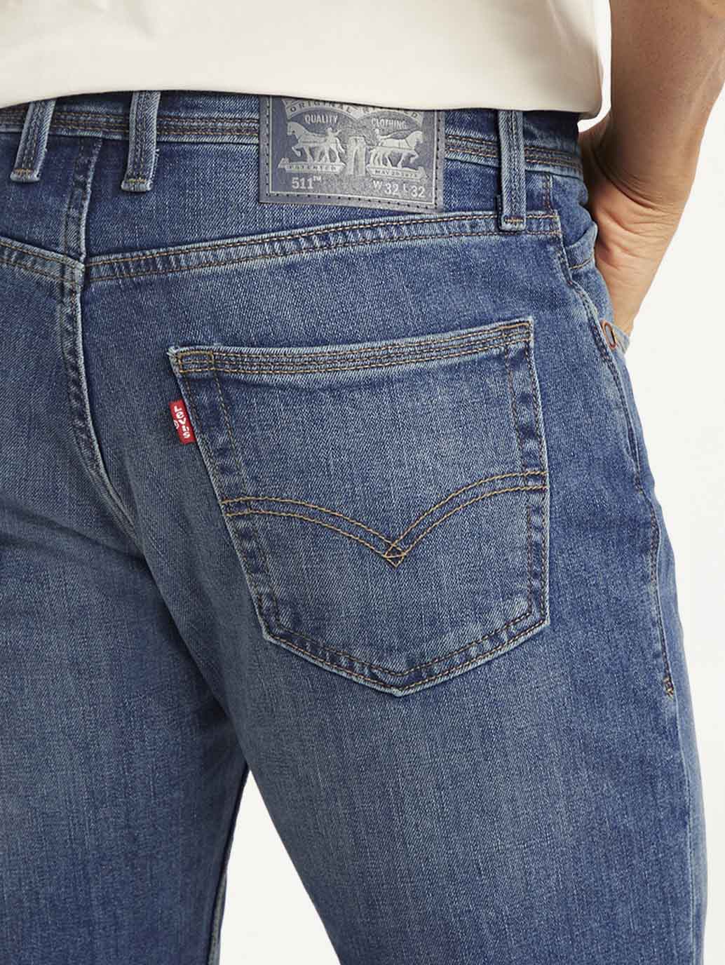 Close-up of Levi's men's 511 slim fit blue mid-rise jeans showing denim fabric and stitching details.