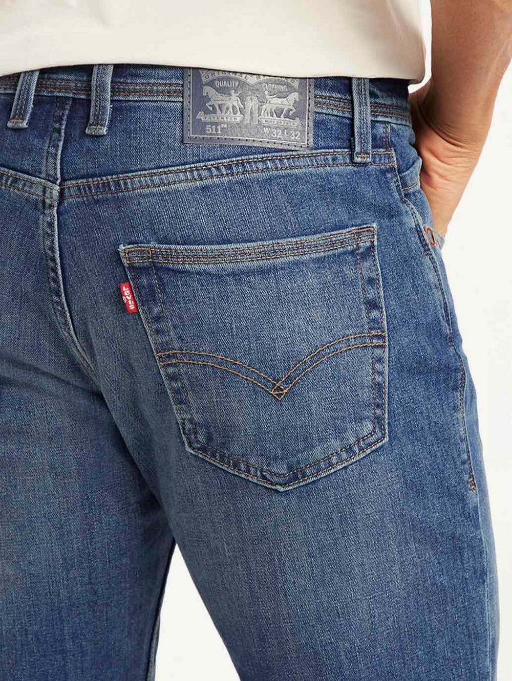 Close-up of Levi's men's 511 slim fit blue mid-rise jeans showing denim fabric and stitching details.