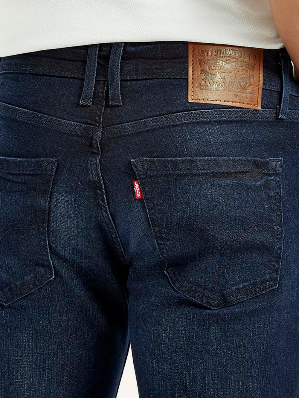 Levi's men's dark blue slim fit mid-rise jeans with detailed stitching and classic five-pocket design.