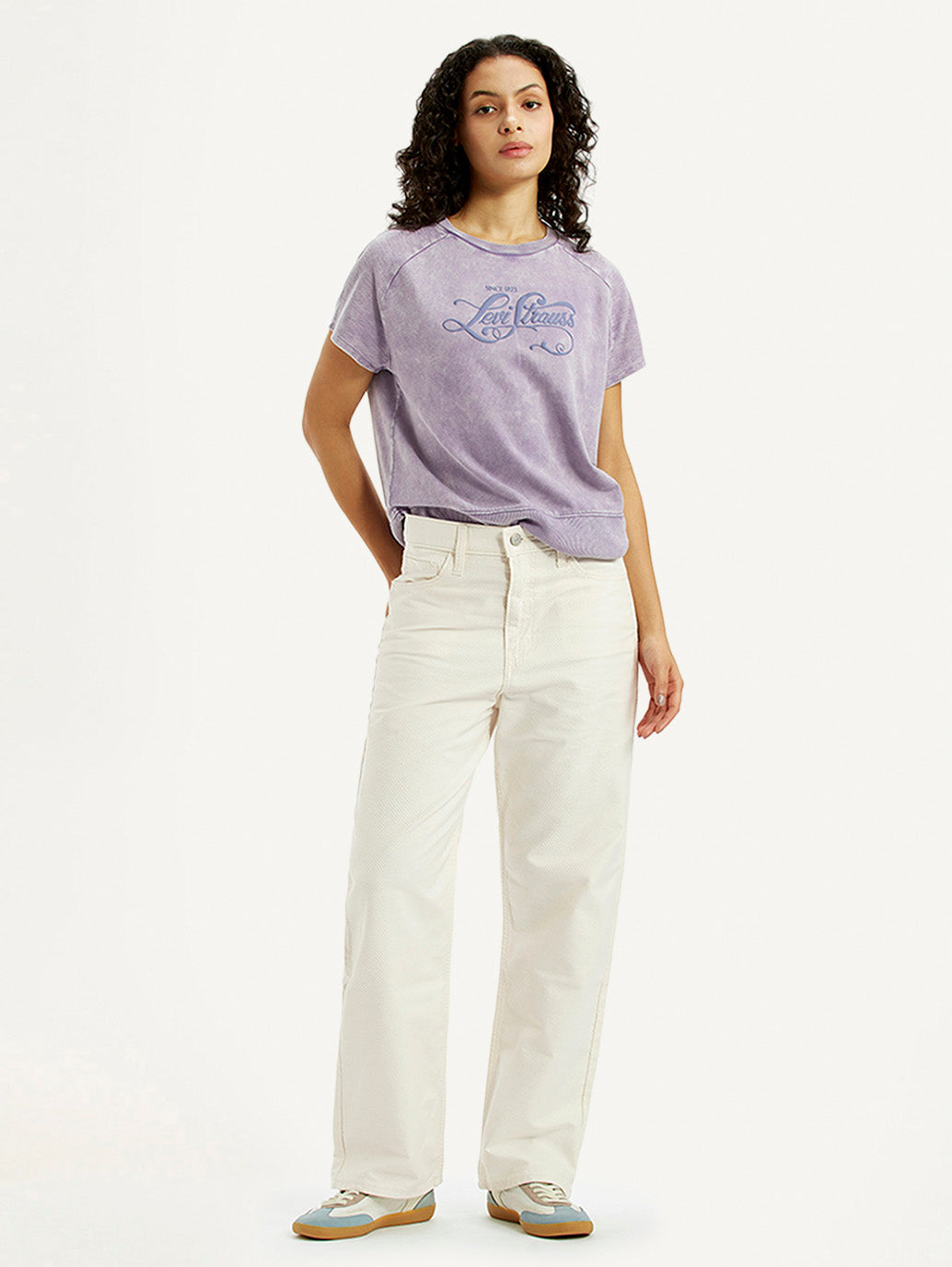 Levi's women's off-white ribcage straight-fit high-rise jeans, styled on a model showcasing the denim's fit and texture.