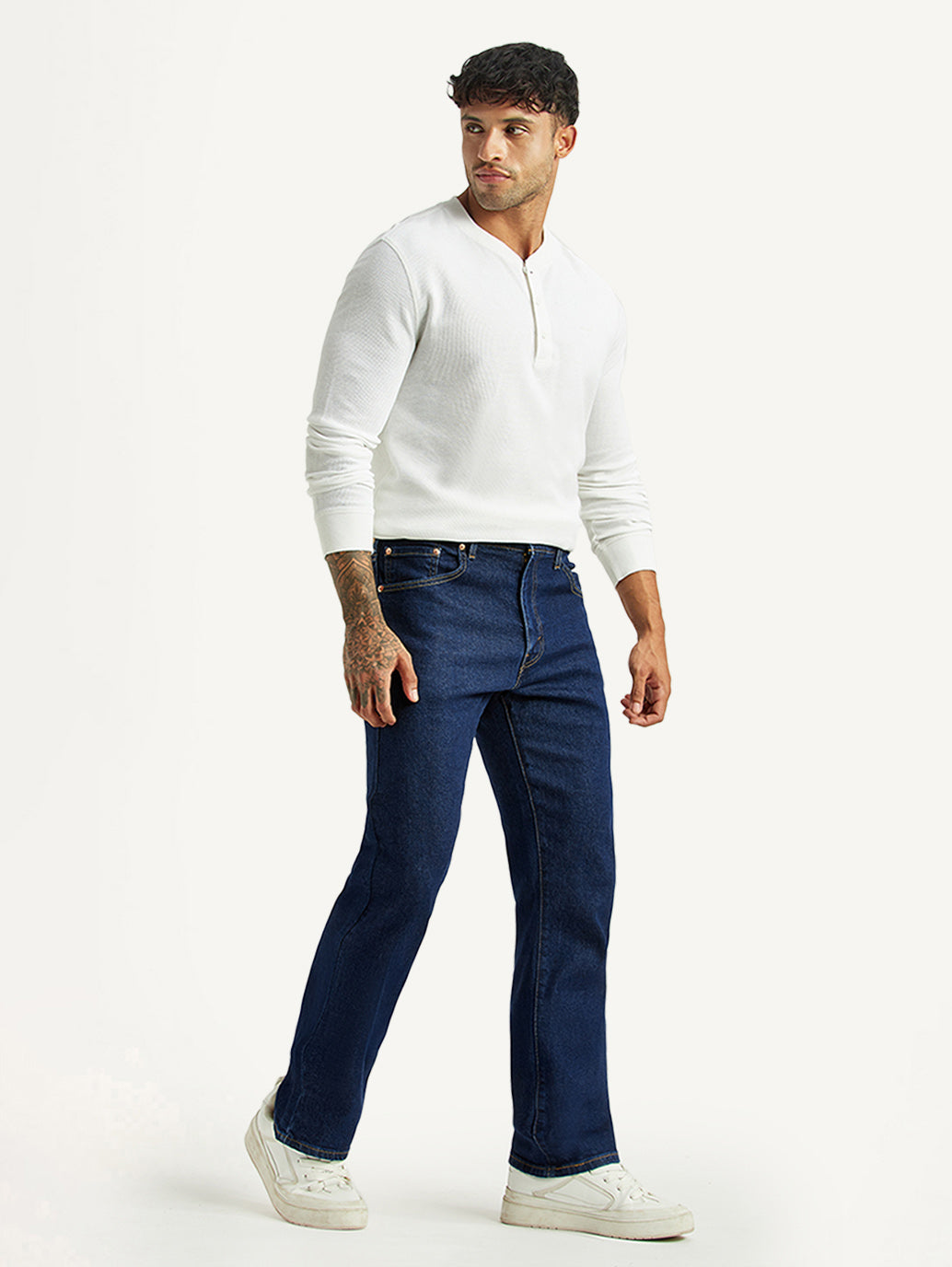 Levi's men's dark blue bootcut mid-rise jeans shown from the side, featuring classic denim style and fit.