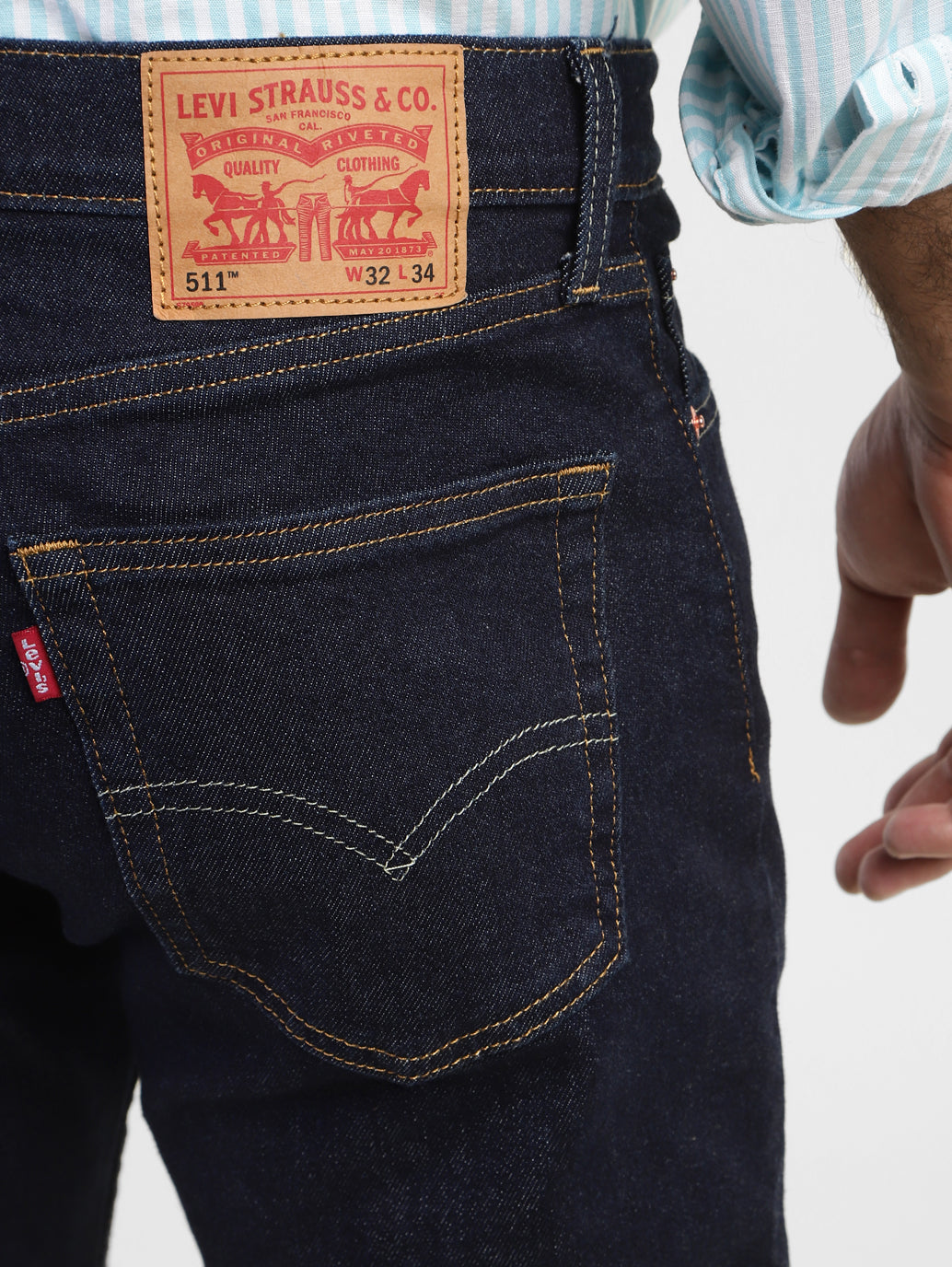 Levi's men's navy blue 511 slim fit mid-rise jeans showing back pocket details and classic stitching.