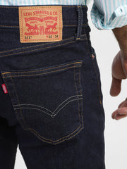 Levi's men's navy blue 511 slim fit mid-rise jeans showing back pocket details and classic stitching.