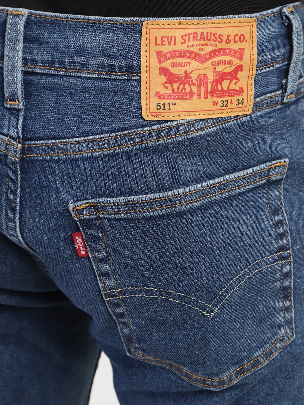 Back view of Levi's men's 511 blue slim fit mid-rise jeans showing back pockets and stitching details.