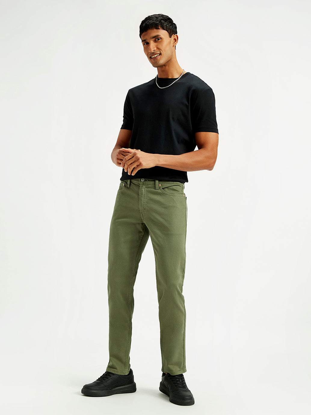 Levi's men's slim fit mid-rise jeans in olive green, showcasing front view with pockets and classic denim texture.