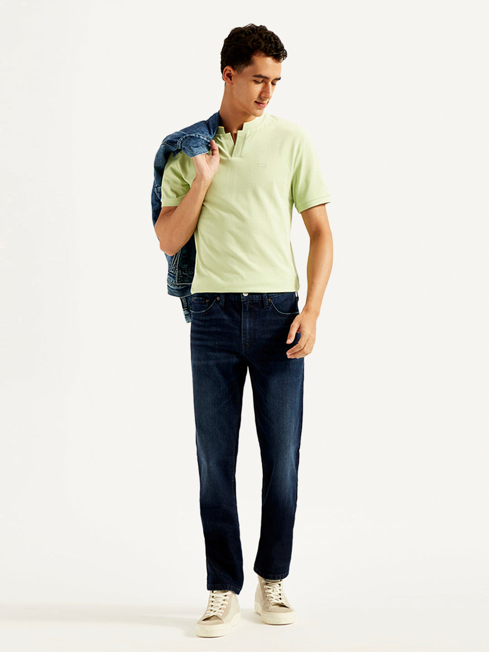 Levi's men's 511 blue slim fit mid-rise jeans, shown on a model, featuring classic five-pocket design and modern fit.