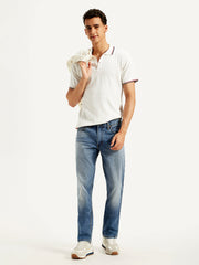 Levi's men's 511 blue slim fit mid-rise jeans displayed on a model, showcasing the classic denim style and modern fit.