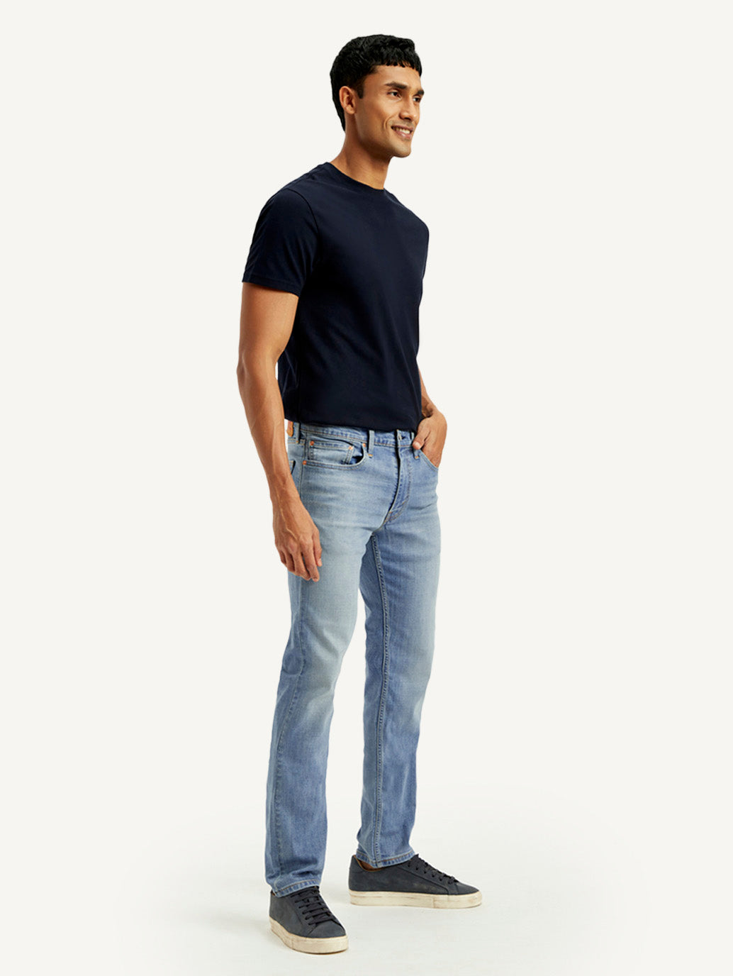 Levi's men's 511 light blue slim fit mid-rise jeans shown from side view, casual denim style with classic stitching.