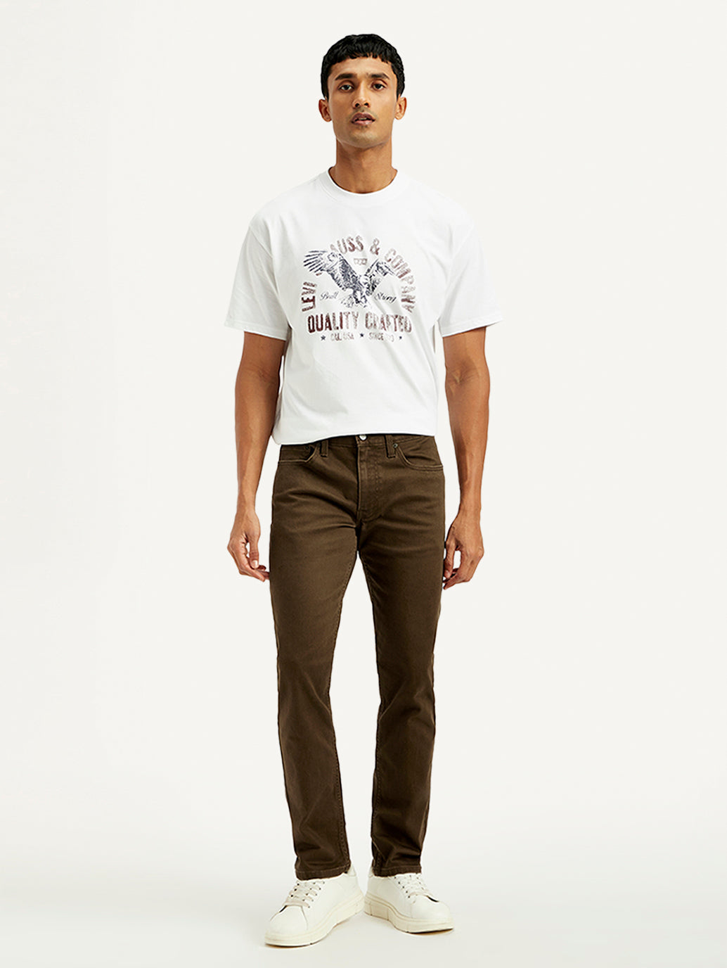 Levi's men's brown 511 slim fit mid-rise jeans, front view showing classic five-pocket design and tapered leg fit.