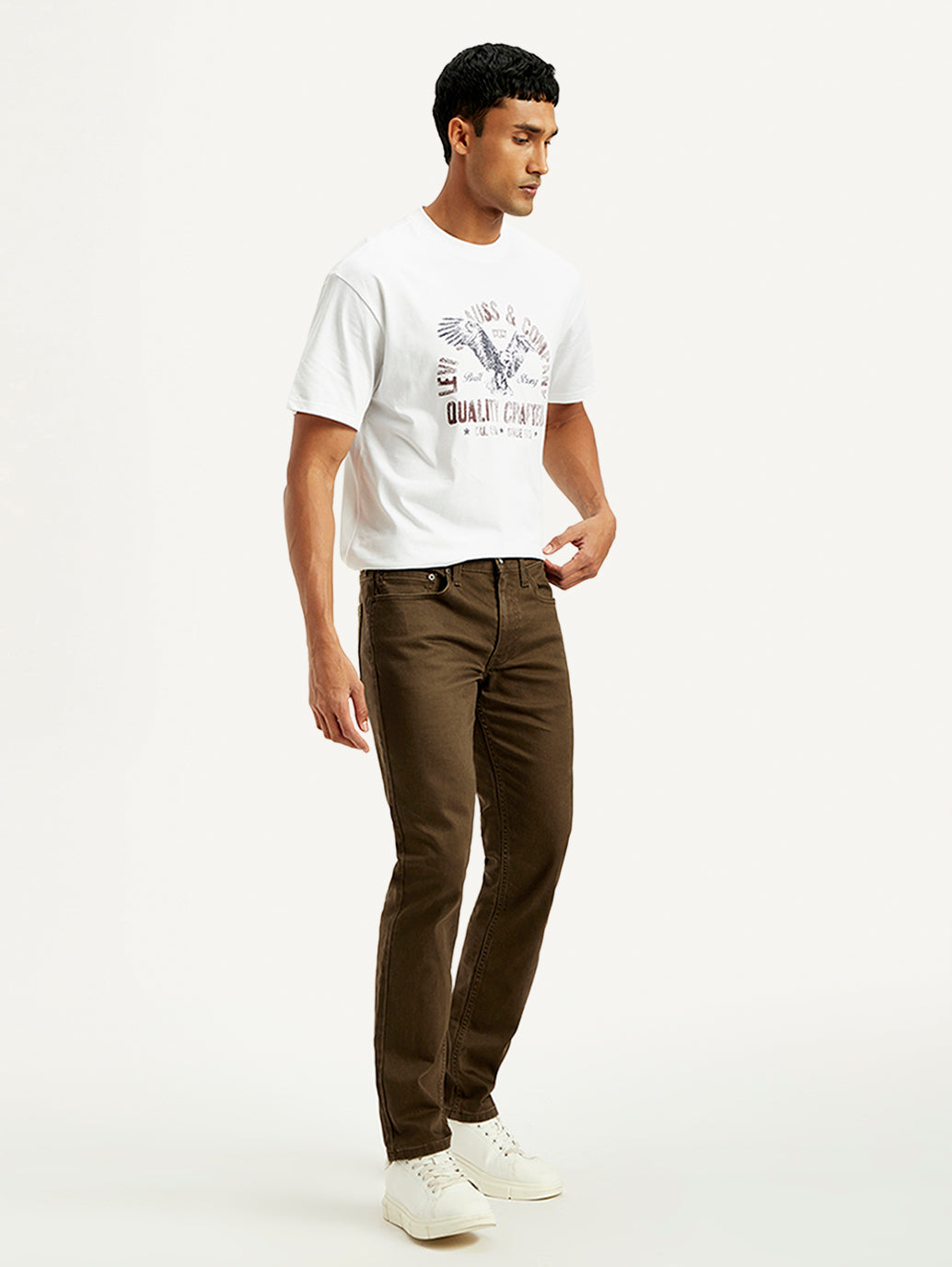 Levi's men's brown 511 slim fit mid-rise jeans shown from the side, featuring classic denim style and tapered fit.