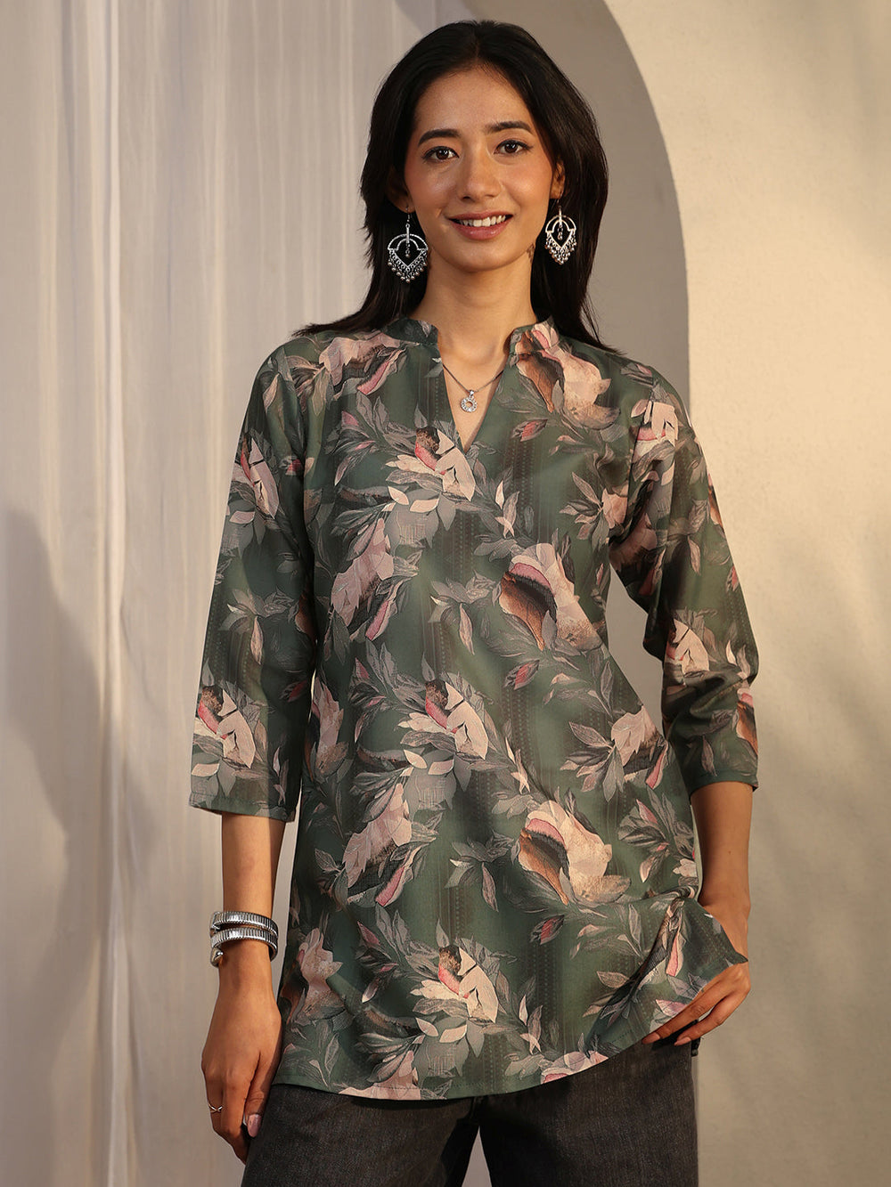 Green printed cotton blend straight short kurti for women, Libas brand, with a vibrant floral design and short sleeves.