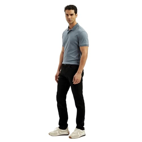 Levi's men's 511 black slim fit mid-rise jeans hanging on a rack, showcasing the classic style and sleek fit.
