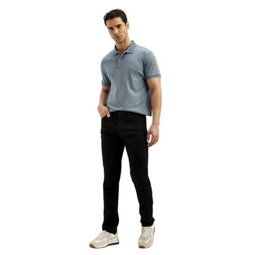 Levi's men's 511 black slim fit mid-rise jeans hanging on a rack with front pockets and belt loops.