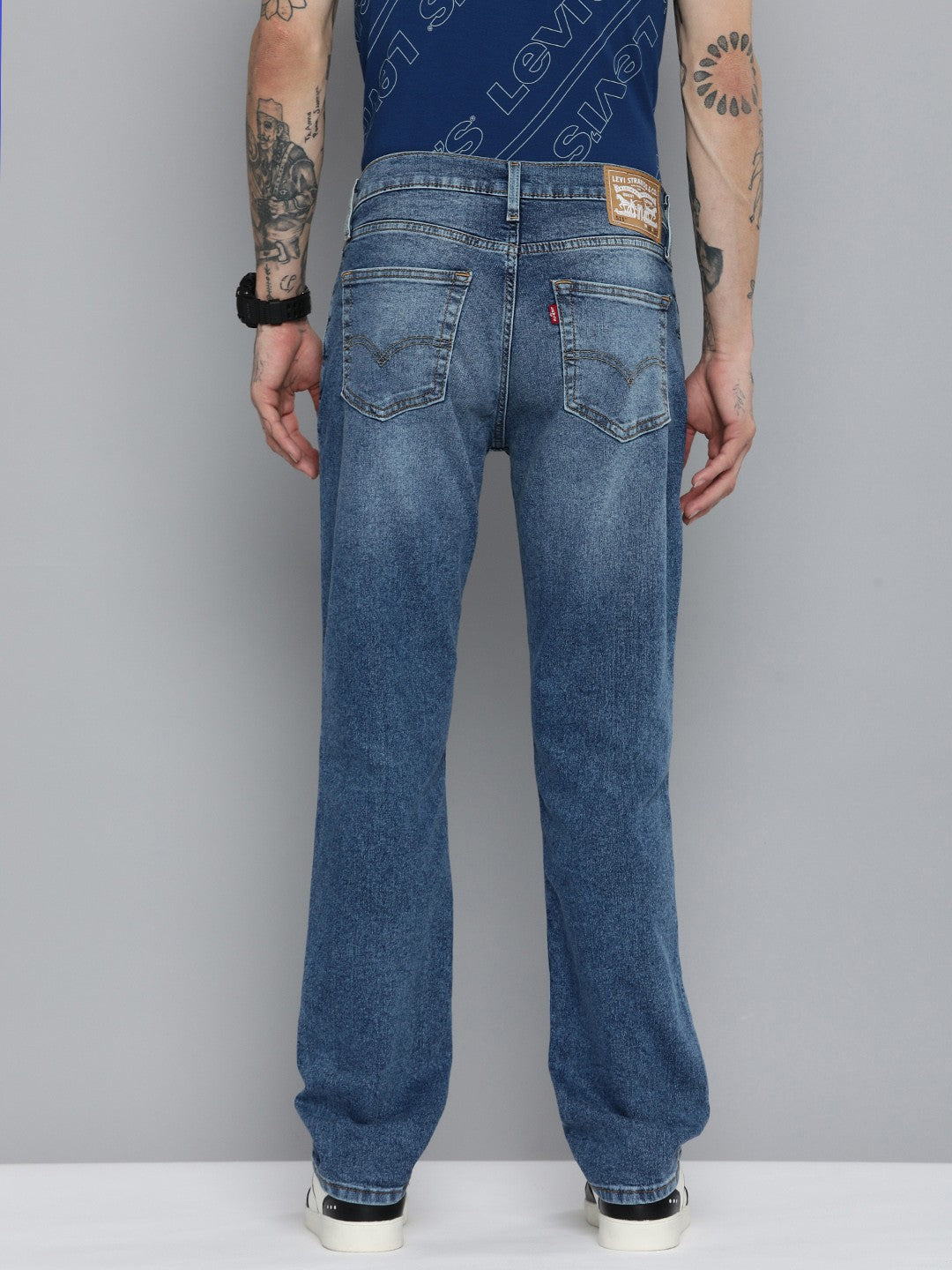 Levi's men's 511 blue slim fit mid-rise jeans, shown on a model, featuring classic five-pocket design and casual style.
